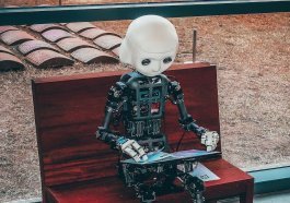 black and white robot toy on red wooden table