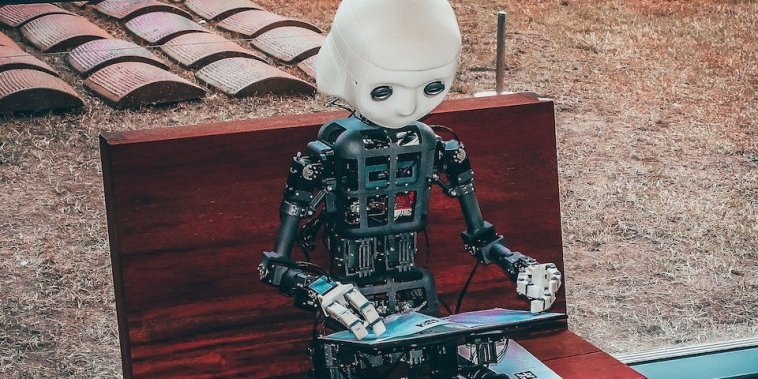 black and white robot toy on red wooden table