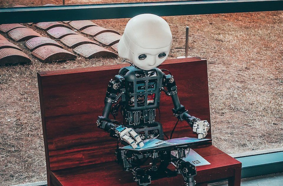 black and white robot toy on red wooden table
