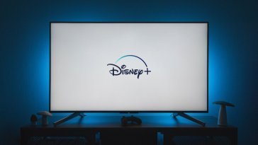 a flat screen tv sitting on top of a wooden table