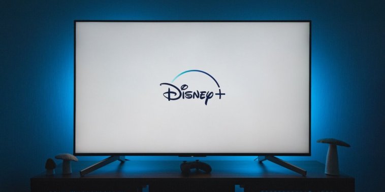 a flat screen tv sitting on top of a wooden table